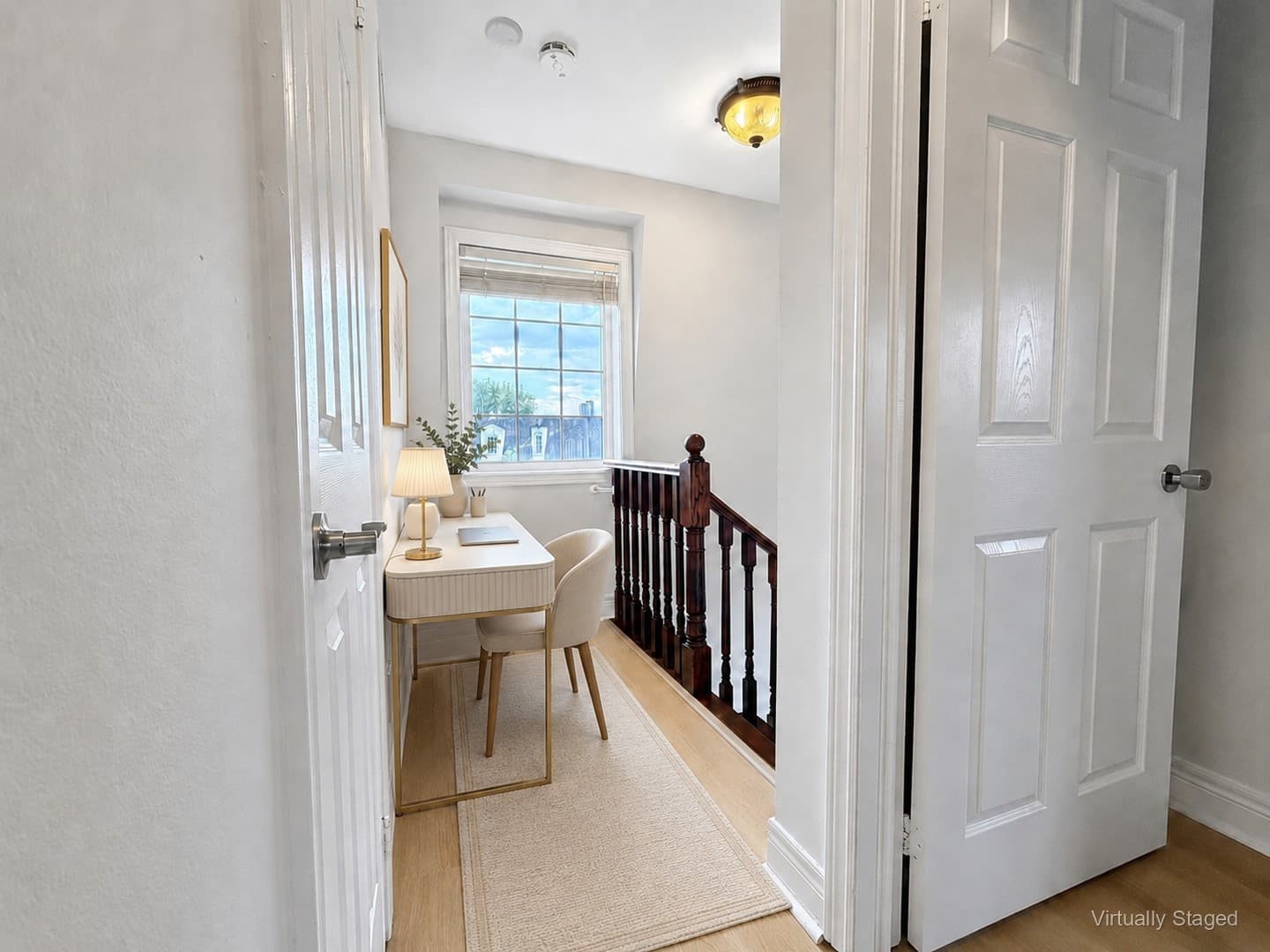 Virtually staged bright window on the upper landing