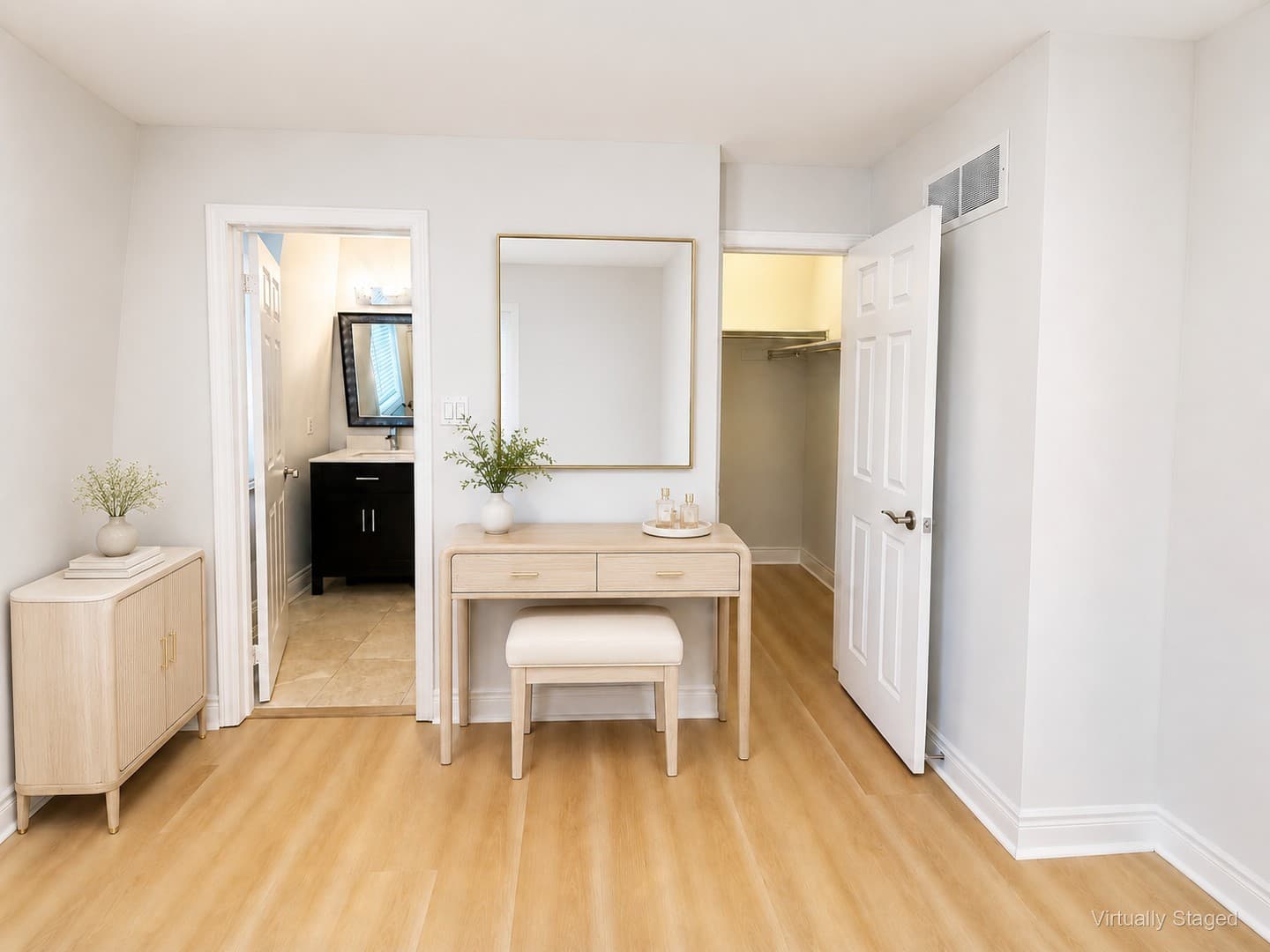 Virtually staged view from primary bedroom into ensuite bathroom and walk-in closet